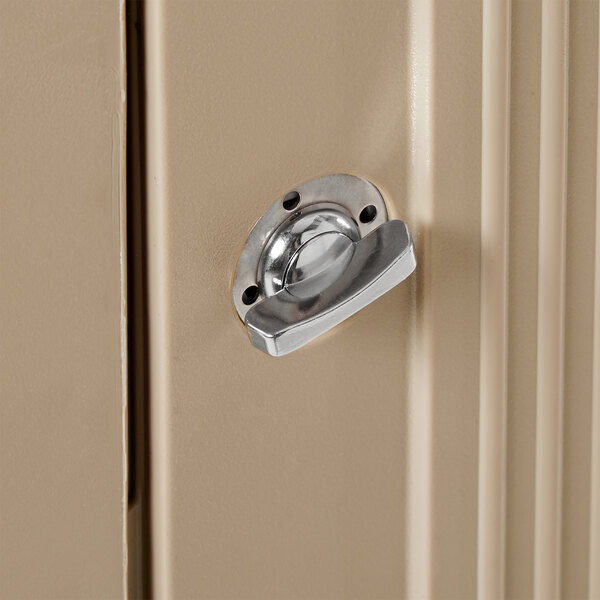 A Rubbermaid Plaza beige square trash container with a side opening on a door.