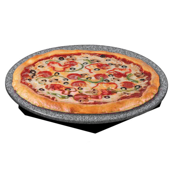 A pizza on a Hatco heated stone shelf with pepperoni and olives.