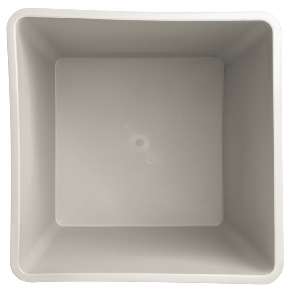 A beige square rigid plastic liner with a hole in the middle.