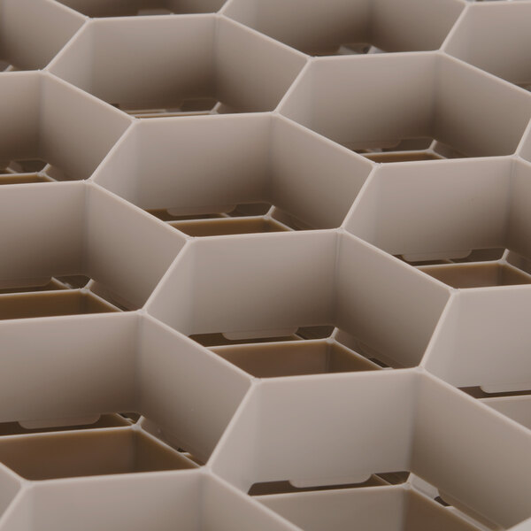 A close up of a white plastic grid with hexagonal compartments.