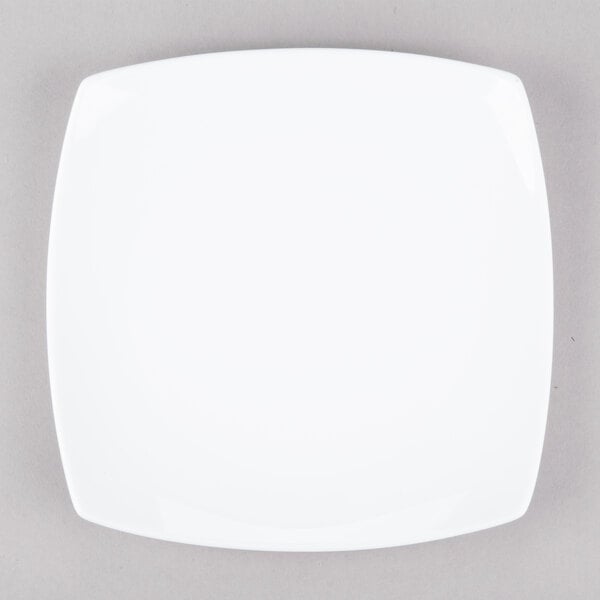 A white square 10 Strawberry Street porcelain plate with a white rim on a gray surface.
