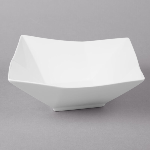 A white square bowl on a gray surface.