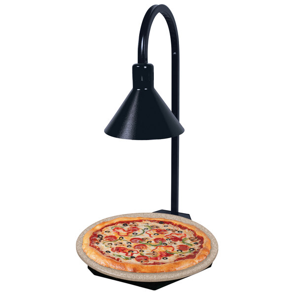 A pizza on a Hatco heated stone shelf with a display lamp.