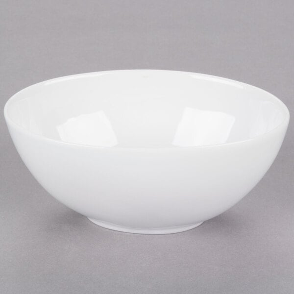 A white 10 Strawberry Street Royal porcelain bowl with a white rim on a gray surface.