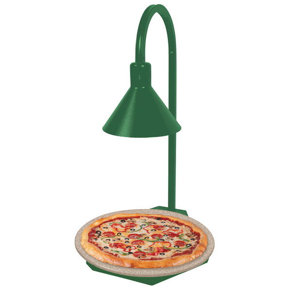 A Hatco heated stone shelf with a green lamp over a pizza on a plate.