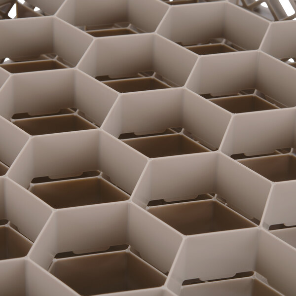 A close up of a beige hexagon-shaped Vollrath Traex glass rack.