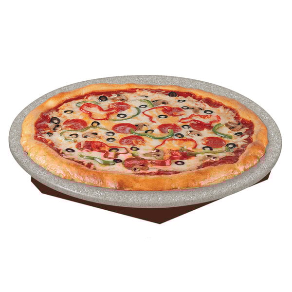 A pizza on a Hatco heated stone shelf with pepperoni and olives.