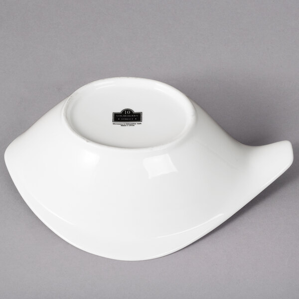 A white bowl with a handle and a black label.