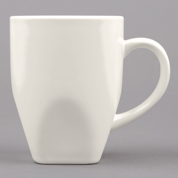 A white Tuxton Bistro China mug with a handle.