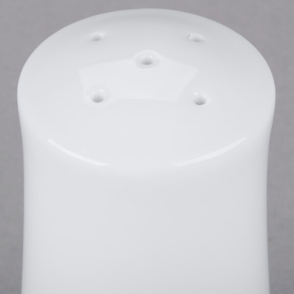 A white square porcelain salt shaker with holes.