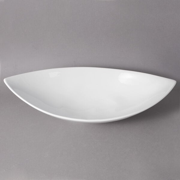 A white bowl with a curved edge on a white background.