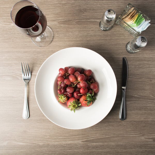 A Tao bowl filled with fruit on a table.