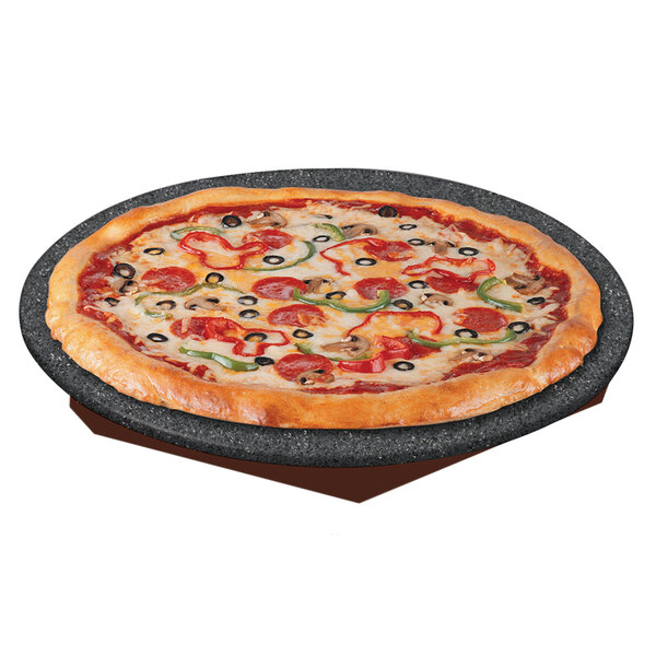 A pizza on a Hatco heated stone shelf with pepperoni and olives.