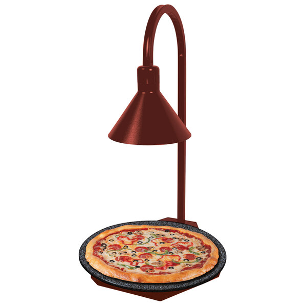 A pizza on a Hatco heated stone shelf with a display lamp.