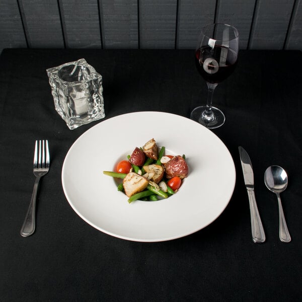 A plate of food on a table with a fork and knife.