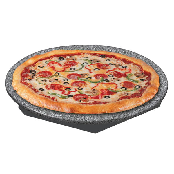 A pizza on a Hatco heated stone shelf with pepperoni and olives.