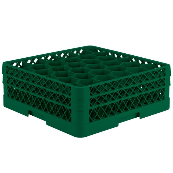 A green plastic Vollrath Traex glass rack with 30 hexagonal compartments.