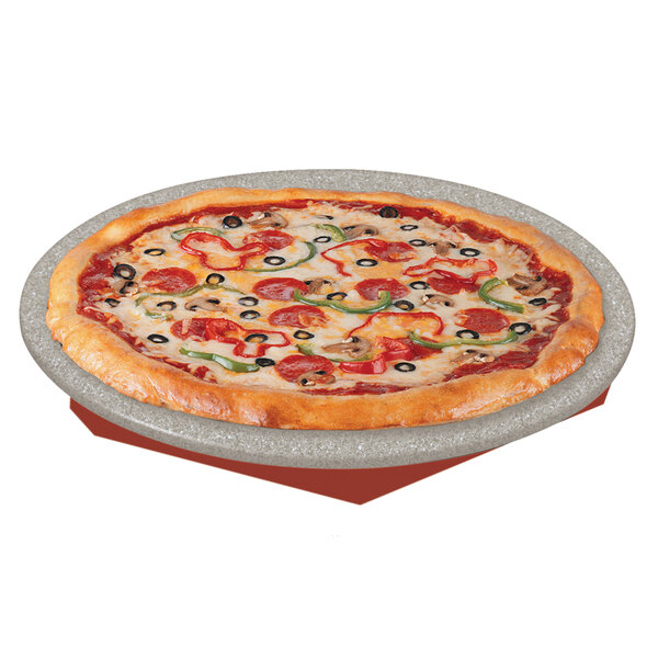 A pizza on a Hatco heated stone shelf with pepperoni and olives.