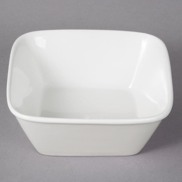 A 10 Strawberry Street Whittier white square bowl on a gray surface.