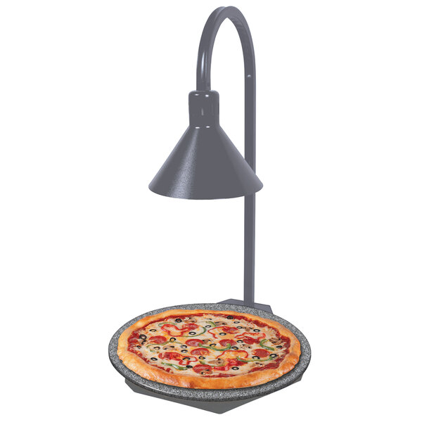 A pizza on a Hatco heated stone shelf with a display lamp.