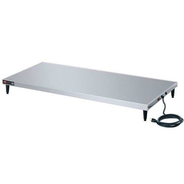 A white rectangular stainless steel Hatco heated shelf with a black power cord.