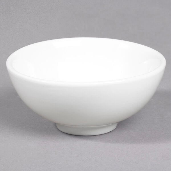A white Whittier porcelain sauce dish.
