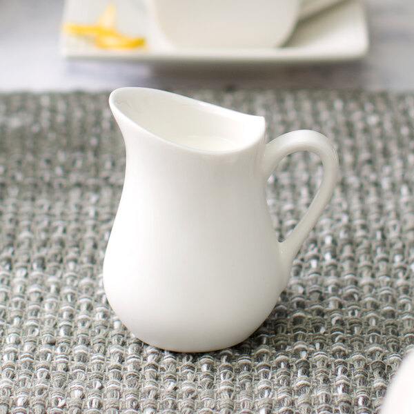 A 10 Strawberry Street Whittier white porcelain jug on a table.