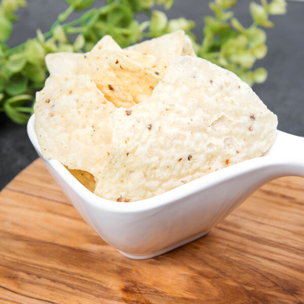 A white bowl with chips in it.