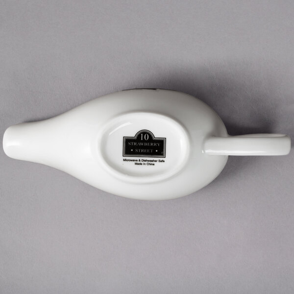 A white porcelain gravy boat with an oval shape.