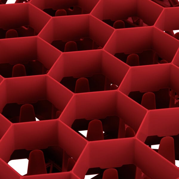 A red hexagon-shaped Vollrath Traex rack with 30 compartments.
