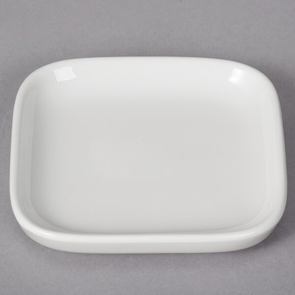 A white porcelain replacement lid with a small rim.