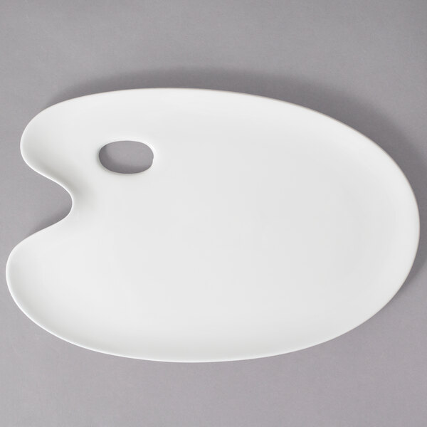 A white porcelain china platter with a hole in the middle.
