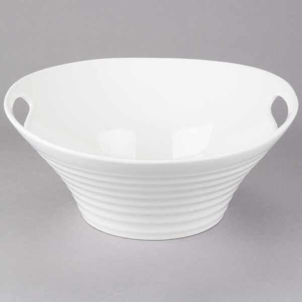 A white Oslo porcelain deep handle bowl on a gray surface.
