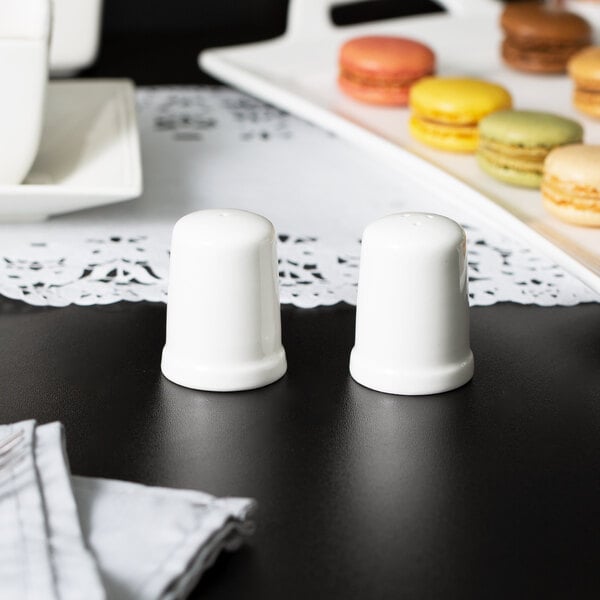 A table with a 10 Strawberry Street white porcelain salt and pepper set on it.
