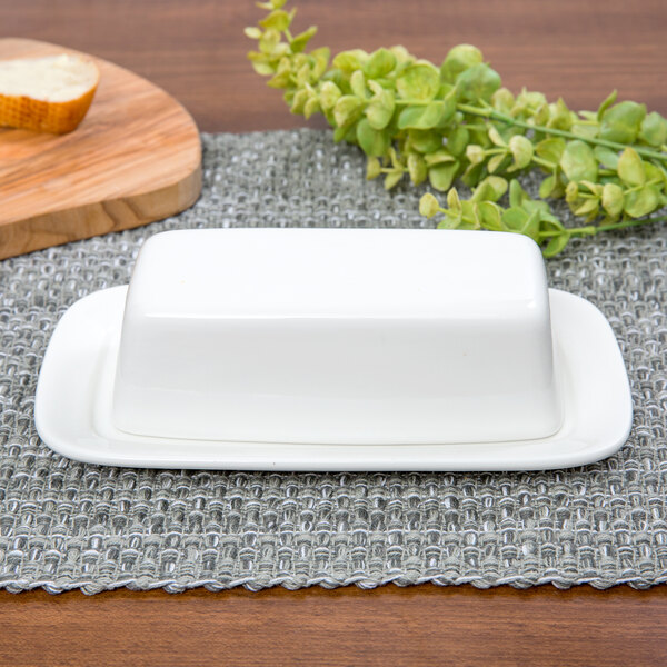 A 10 Strawberry Street white porcelain covered butter dish on a table.