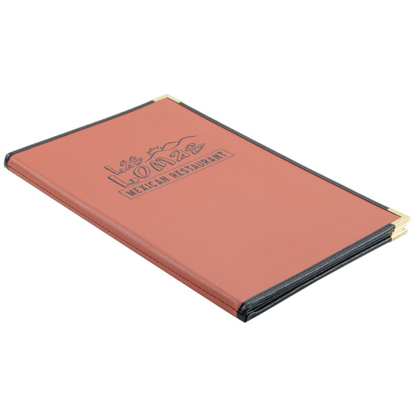 A red and black leather-like Menu Solutions Royal Select menu cover with a black logo on a table.