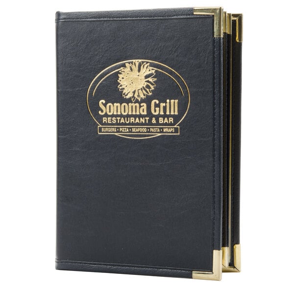 A black leather Menu Solutions Royal Select series menu cover with a custom logo on a table.