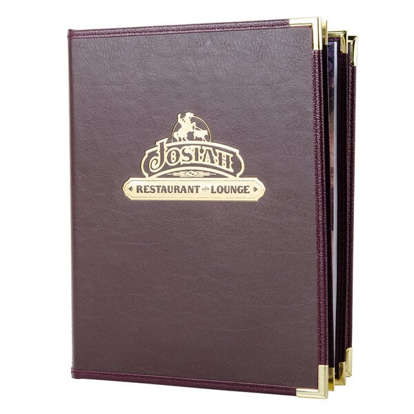 A brown leather Menu Solutions Royal Select menu cover with a logo on a table.