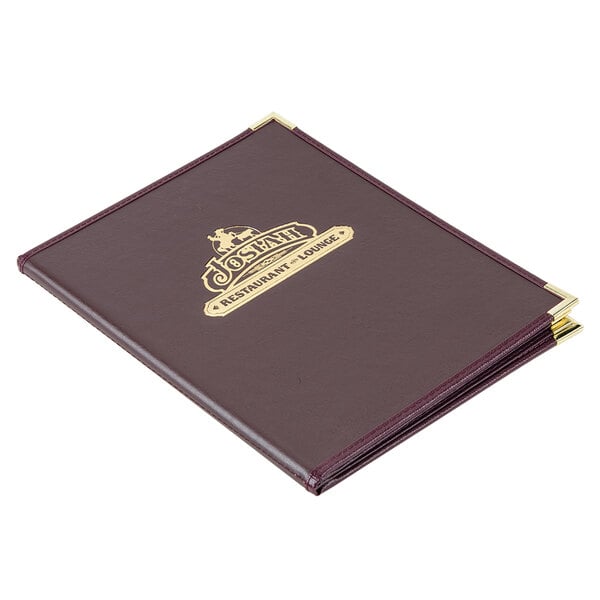 A brown leather Menu Solutions Royal Select menu cover with a gold logo on a table.
