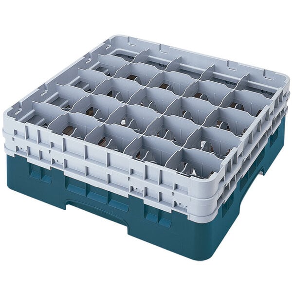 A teal plastic Cambro glass rack with many compartments and extenders.