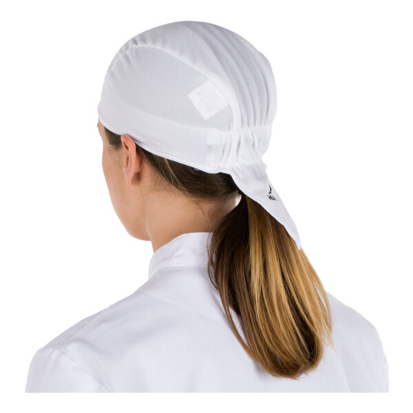 A person wearing a white head covering and white clothing, viewed from the back.