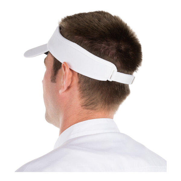 A person wearing a white visor with an adjustable strap, viewed from the back.