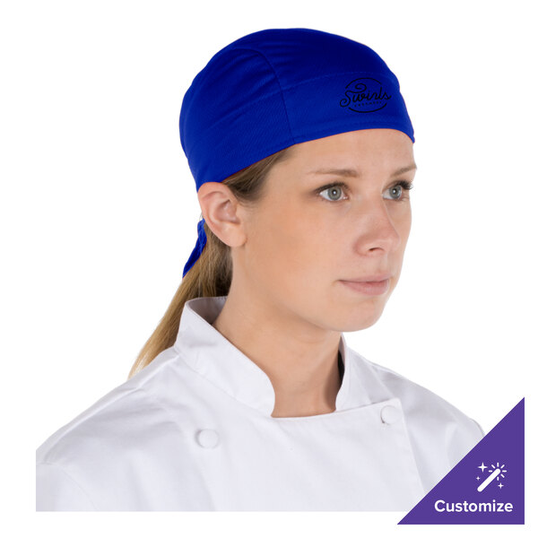 A chef wearing a royal blue Headsweats Shorty Chef Cap.