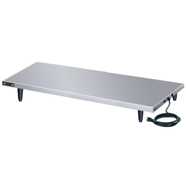A stainless steel rectangular Hatco heated shelf warmer on a table with a power cord.