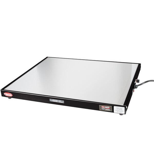 A white rectangular object with a black border: a Hatco Glo-Ray heated shelf warmer.