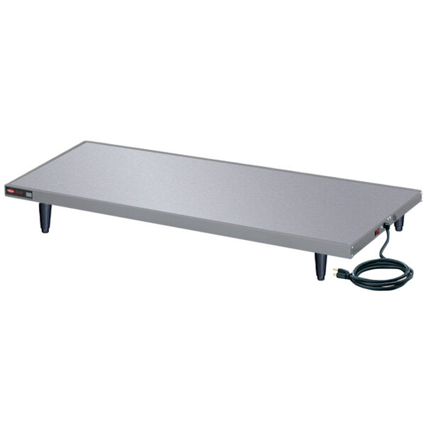 A Hatco Glo-Ray heated shelf on a metal table.