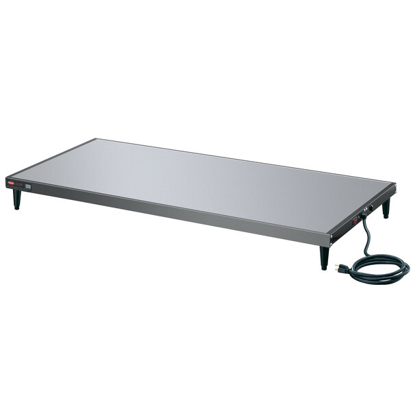 A white rectangular Hatco heated shelf with a black cord.