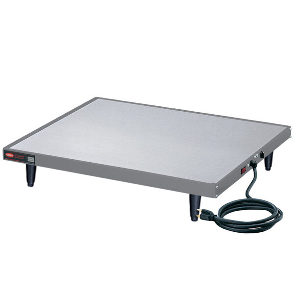 A rectangular grey Hatco heated shelf warmer on a table with a black power cord.