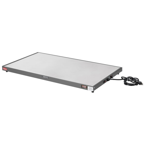 A white rectangular Hatco heated shelf with black cords.