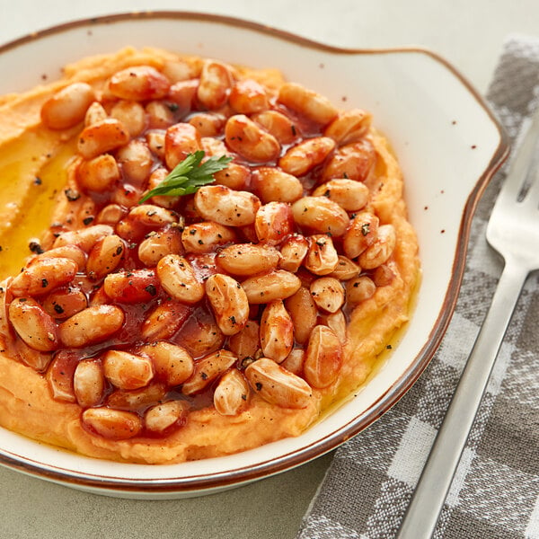 A plate of dried Great Northern beans and mashed potatoes on a table.